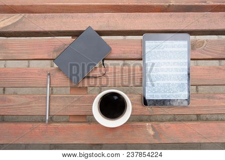 Business Outdoor Flat Lay. Top View Of Note Pad, Pen, Black Coffee Cup And Tablet Computer At Wooden