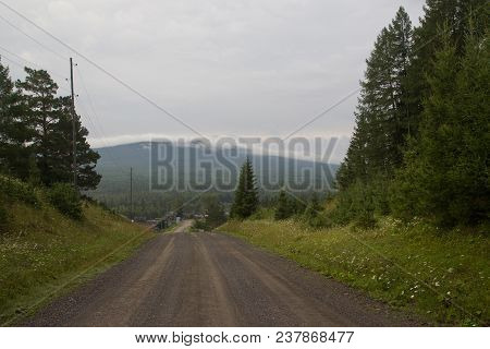 A Dirt Road With A View Of The Mountains In The Southern Urals. Russia