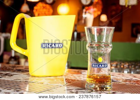 Close Up On A Ricard Jug And A Water Bottle With Its Logo. Ricard Is A Pastis, An Anise And Licorice