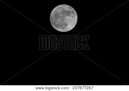 Big Central Full Moon With Craters In The Dark Sky