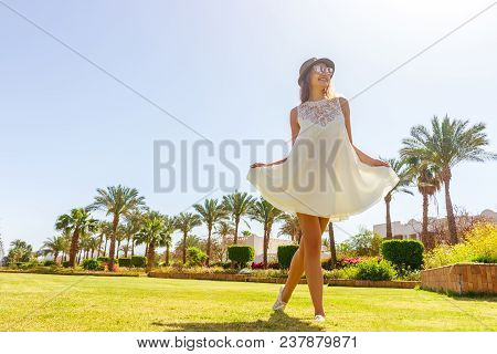 Woman Having Fun And Enjoying Relaxing Summer Tropical Vacation At The Park.