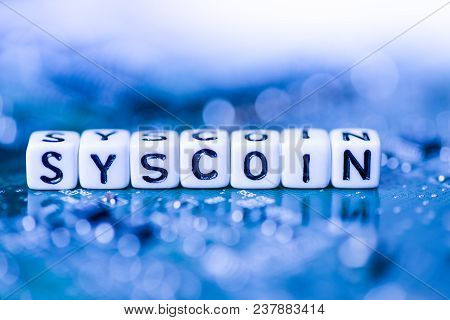 Word Syscoin Formed By Alphabet Blocks On Mother Cryptocurrency Closeup