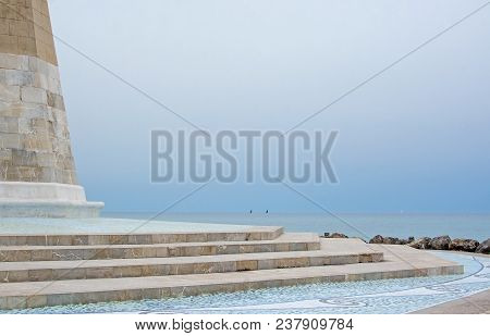 Sailboats On The Horizon And Mosaic Tower On An Overcast Day In Molinar, Mallorca, Spain.