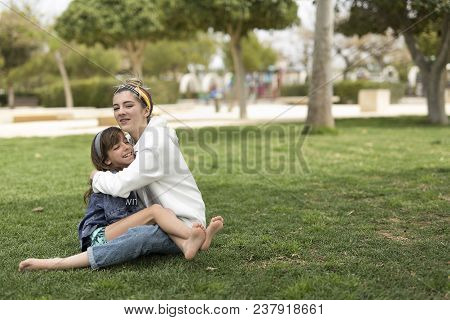 Two Sisters Who Sitting Loving Each Other.