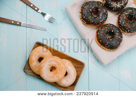 Overhead View Of Chocolate Cake Donuts With Salted Caramel Glaze With A Cup Of Espresso On Marble Ta