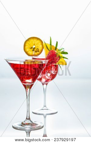 Summer Cocktails Decorated With Tropicl Fruits And Leaves On A Reflective Surface. Negative Space.