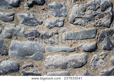 Stone Wall Of Old Masonry Close-up. Background And Texture.
