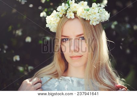 Attractive Modest Young Girl With Blonde With Jasmine Flowers Wreath On Head Long Hair And Natural M