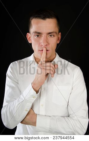 Keep Silence. Attractive Guy. Shhhh. Man Was Silent. Black Background.