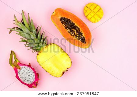 Tropical Fruit Flat Lay With Dragon Fruit, Pineapple, Papaya And Mango On A Pastel Pink Background. 