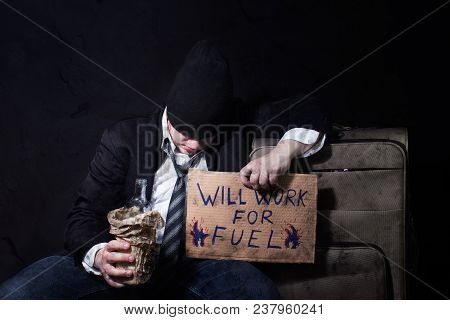 Photo Of A Drunk Homeless Businessman Sleeping On Travel Suitcase With Empty Bottle And Cardboard Si