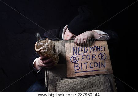 Homeless Business Man Sleeping On Travel Suitcase With Empty Bottle And Cardboard Sign.