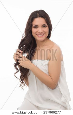 Half Length Image Of Sexy Brunette In White Dress Touching Her Healthy Curlu Hair. Beauty Concept. M