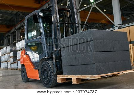 Auto Loader With Aerated Concrete Blocks. Forklift Truck With Slabs Working Inside Factory Workshop 