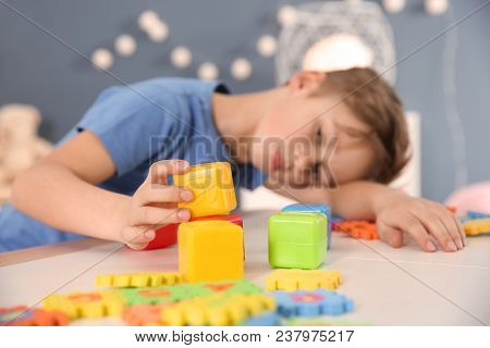 Little Boy With Autistic Disorder Playing At Home, Closeup Of Cubes