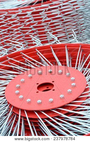 New Red Tedder For Trailer In Agricultural Machinery For Gathering Hay. Close Up