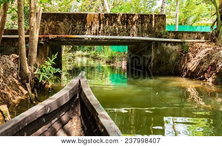 Small Row Boat Is About To Pass Under A Very Low Bridge