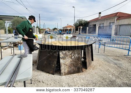 Orihuela, Spain- November 24, 2019: Chef Preparing Giant Paella In The Festivities In Honor To The M