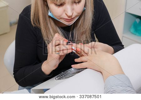 Manicuring Nails - Application Of Base Coat. Selective Focus, High Key