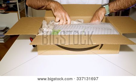Paris, France - Mar 11, 2019: Curious Man Unboxing Unpacking From Amazon Parcel New Nvidia Quadro Rt
