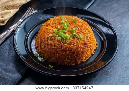 Colombian Cuisine Red Rice With Green Onion Garnish