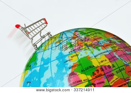 Shopping Cart Over Eath Globe - Concept Of Shopping And Global Market