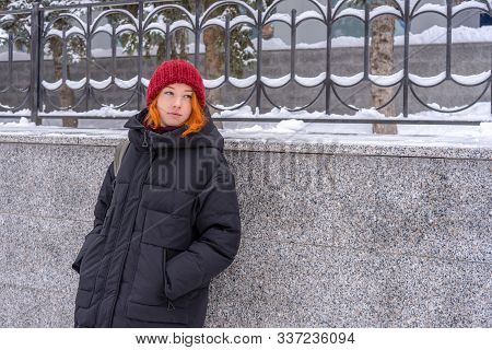 Teen Girl Wearing Casual Clothes Walking On Snow Covered City Street In Winter. Young Lady Spending