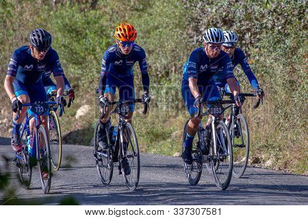 Villa De Leyva, Boyaca, Colombia - December 1, 2019:  Men And Women Of All Ages Ride Bicycles During