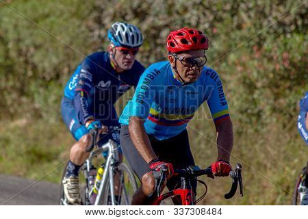 Villa de Leyva, Boyaca, Colombia - December 1, 2019:  Men and women of all ages ride bicycles during