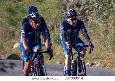 Villa de Leyva, Boyaca, Colombia - December 1, 2019:  Men and women of all ages ride bicycles during