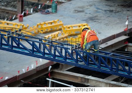 A Construction Worker Do A Job Such As Painting Welding In A Construction Site.