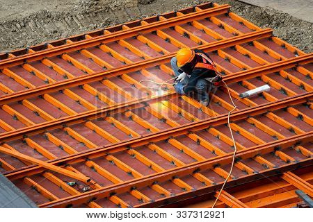 A Construction Worker Do A Job Such As Painting Welding In A Construction Site.