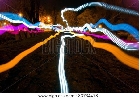 Abstract Dark Background With Multicolored Long Lines Of Light