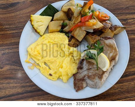 Fresh Island Ahi Fish, Paniolo Potatoes, And Scrambled Eggs On White Plate.