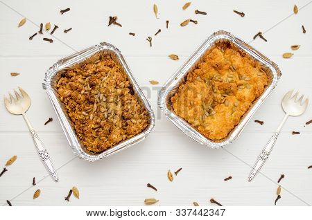 Indian Food, Fruit Pies, Subhadra And Mithai, In Foil Plates On A White Background, Sprinkled With S