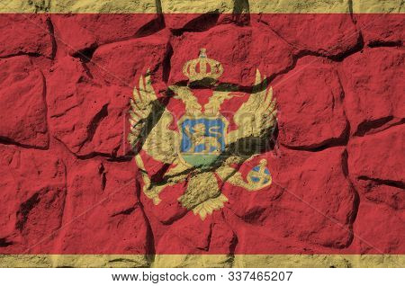 Montenegro Flag Depicted In Paint Colors On Old Stone Wall Closeup. Textured Banner On Rock Wall Bac