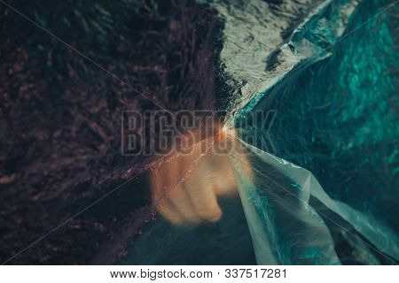 Beautiful Abstract Plastic Cellophane  Bag Background. Human Hand Shows Forefinger Stop.  No Plastic