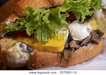 Croissant Sandwiches Served On Wooden Board. Croissants With Egg, Melted Cheese, Parsley, Chicken Ha