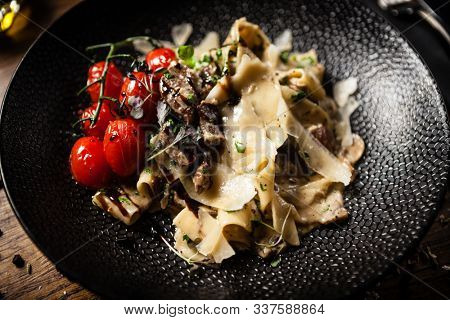 Black Angus pappardelle pasta with beef, champignon and parmegano cheese