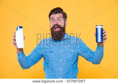 Bath Cosmetics. Man Bearded Hipster Hold Shampoo Bottles. Hair Care. Shampoo For Daily Use. Skin Lot