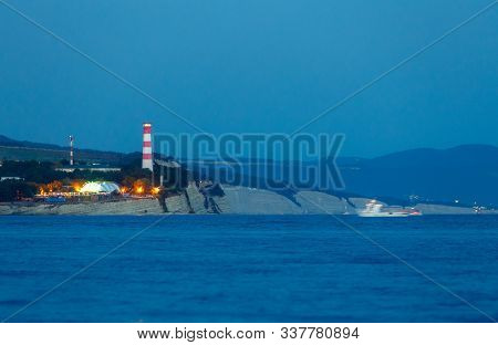 Light The Beacon At The Entrance To The Gelendzhik Bay. Lighthouse At Night Shines Ships In The Blac