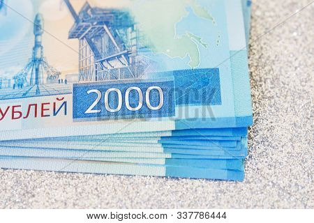 New Cash Banknotes Of Russia On A Silver Background. 2000 Rubles With The Image Of The Vostochny Cos