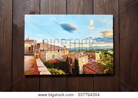 Canvas Photo Print On Brown Wooden Background. Front View Of Colorful Photography Printed On Glossy 