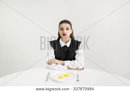 We Are What We Eat. Womans Eating Fried Eggs Made Of Plastic, Eco Concept. There Is So Much Polymers