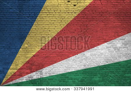 Seychelles Flag Depicted In Paint Colors On Old Brick Wall. Textured Banner On Big Brick Wall Masonr