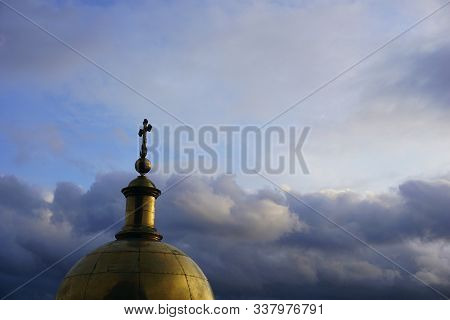 Cross On Top Of A Christian Church Tower Against A Bright Sunset Sky
