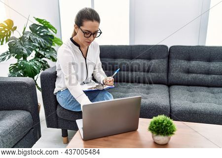 Young hispanic woman having teleconsultation at psychology clinic