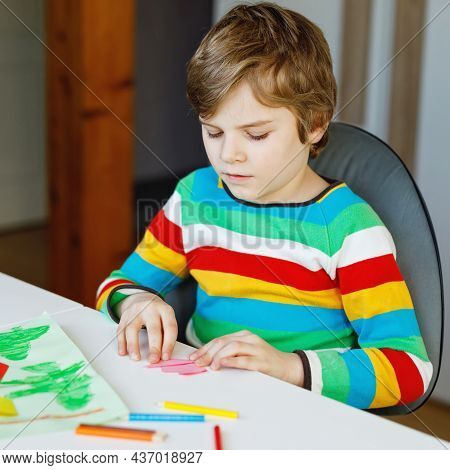 Little Kid Boy Making Paper Origami Tulip Flowers For A Postcard For Mothers Day Or Birthday. Cute C