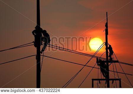 Silhouette Electric Worker Working Late On Pole With Sun Set Sky Abstract Nature Background