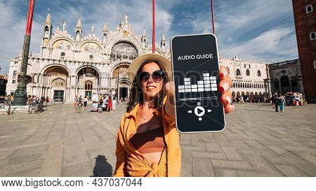 Audio Tour Online App On Digital Mobile Smartphone. Happy Young Student Woman Holding Phone Listenin